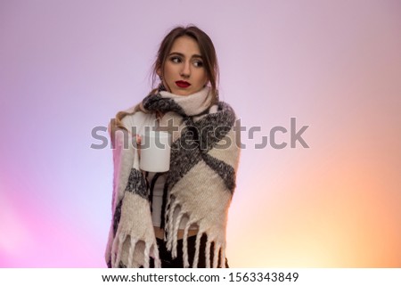 Sick woman with hot cup of tea in warm plaid. Illness and medicine concept