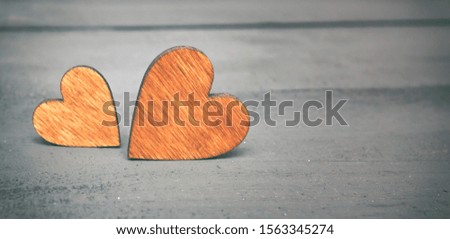 Two wooden hearts on the wooden table