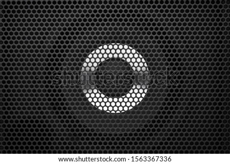 Black guitar amplifier audio speaker with protective grill detail. Close up view.