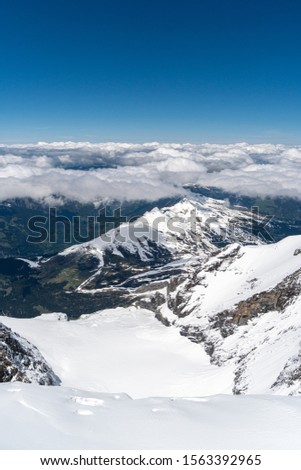 Panoramic view on winter snowy mountains at nice sunny evening. Swiis alps during summer.