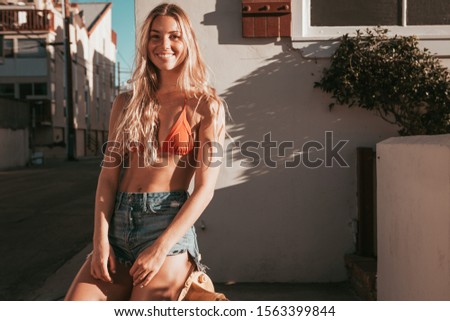 young woman with a bikini and shorts. california