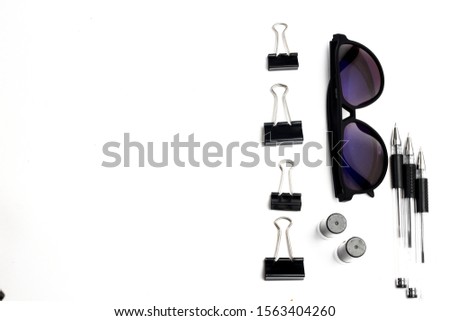 Flat lay of stationary. Exclusive, elegant and professional picture concept.  Men taste. black pen, paper clip, sunglasses.