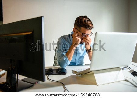 Young man sitting in his office