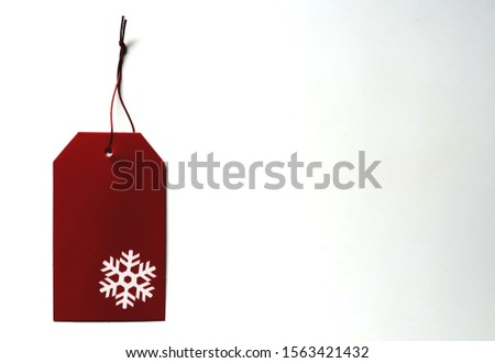 red christmas gift tag isolted on white background with copy space - concept of Christmas holiday season