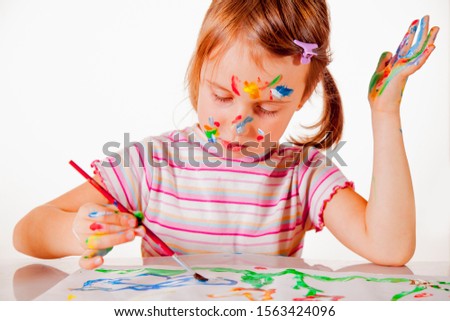 Beautiful young child girl painting a picture. Talent, creativity concept