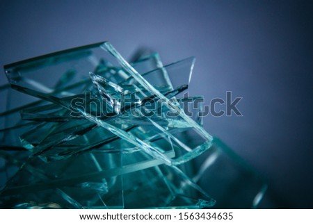 Broken glass background for your images isolated on white. Many large glass fragments scattering from a hammer as a concept of violence