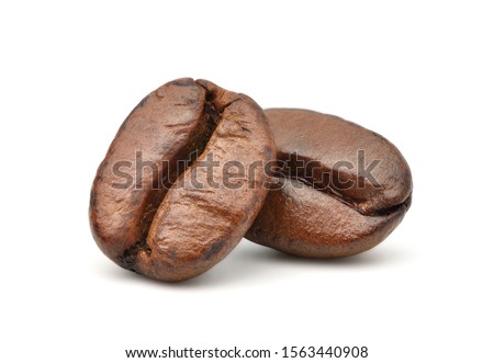 Close-up Two roasted coffee beans isolated on white background. Clipping path Royalty-Free Stock Photo #1563440908