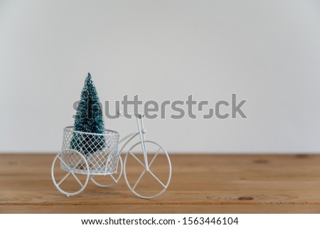 Accessories of Merry Christmas decorations & Happy new year ornaments concept.Bicycle model transfer fir tree object to party season on modern rustic brown & grey stone backdrop.space for design.