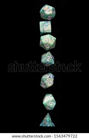 RPG set green dice for playing role playing games on black blackground.