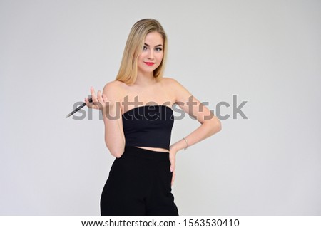 Business training concept with a girl secretary. Portrait of a fashionable beautiful blonde model with long hair, great makeup, on a white background.
