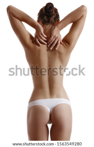 Woman in panties touching her spine, posing standing back to the camera, isolated on white. Plastic surgery, aesthetic cosmetology concept. Close-up.
