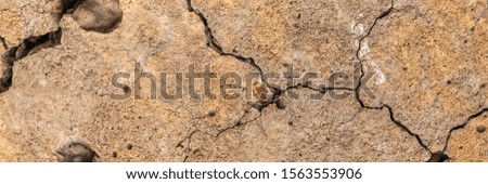 Abstract cement background. Cracked concrete texture closeup. A high resolution old concrete cement with cracks and natural destruction from time and weather conditions.
