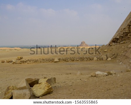 View of the base of the Bent Pyramid with the Pyramid of Amenemhat III (or Black Pyramid) in the background. In Dahshur necropolis, Cairo, Egypt