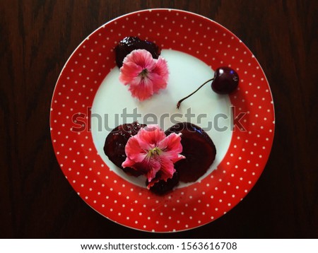 cherry jam on a red plate