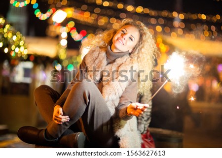 Picture of woman with Bengal lights on winter walk .