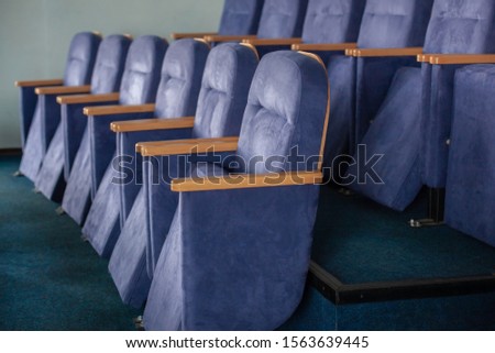 Audience fragment  with seats, row of empty comfortable blue armchairs in an auditorium or meeting room, hall for meetings, seminars, lectures, presentations. Study and business concept