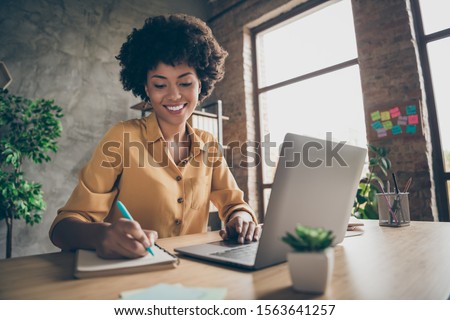 Photo of cheerful pretty cute nice girlfriend having been employed to job as executive smiling toothily sitting at desktop with laptop noting down important information
