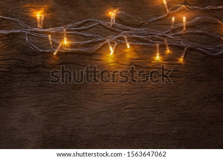 Christmas lights on wooden plank background. Merry Christmas and happy new year with copy space for a text.

