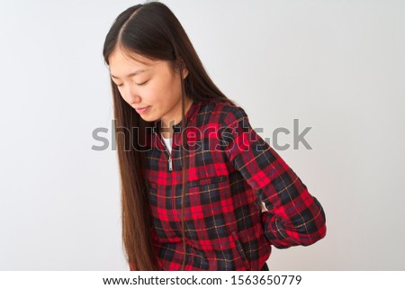 Young chinese woman wearing casual jacket standing over isolated white background Suffering of backache, touching back with hand, muscular pain