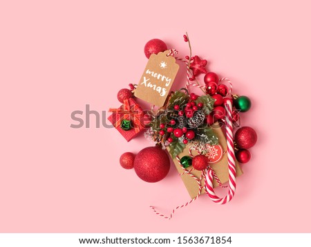 Christmas holiday concept. winter festive decor on pink background. creative modern design for greeting card. Flat lay, copy space.