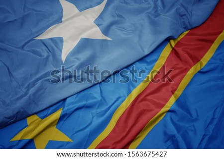 waving colorful flag of democratic republic of the congo and national flag of somalia. macro