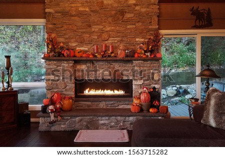 Large Stone Fireplace with Mantle and Hearth During the Fall Season in a Rustic Home