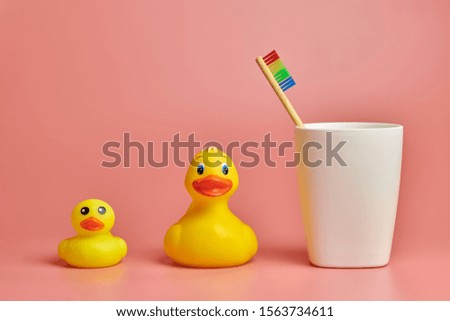 Eco bamboo toothbrush and duck toys. Personal care tool for protect oral cavity, remove plaque and tartar.