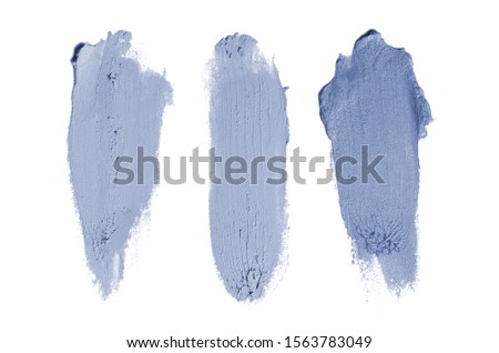 Smear and texture of lipstick or acrylic paint isolated on white background. Stroke of lipgloss or liquid nail polish swatch smudge sample. Element for beauty cosmetic design. Dark blue color