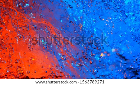 Texture of water illuminated by neon lights, top view