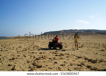 Egypt. Tourists on ATV take pictures of the desert                               