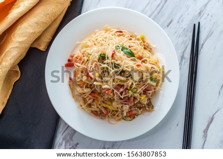 Chinese pork mei fun also known as Singapore-style noodles Royalty-Free Stock Photo #1563807853