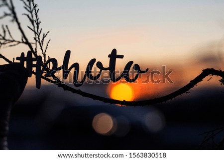 letters with the word photo with a sunset background
