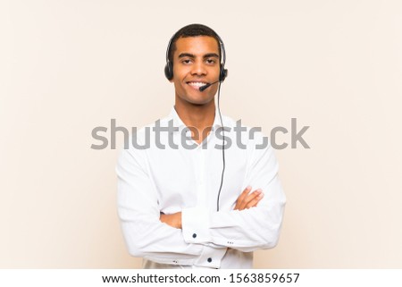 Young brunette man working with a headset smiling a lot Royalty-Free Stock Photo #1563859657
