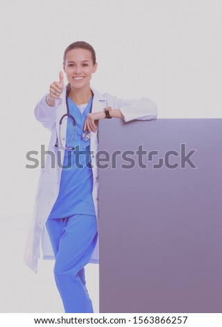A female doctor with a blank billboard. Woman doctor