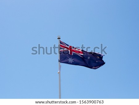 The flag of Australia is a defaced Blue Ensign, a blue field with a Union Jack in the canton (upper hoist quarter), and a large white seven-pointed  Commonwealth Star in the lower hoist  quarter.