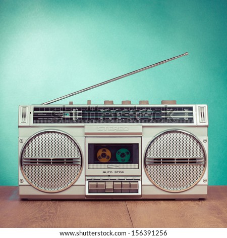 Retro radio and cassette stereo recorder on mint green background