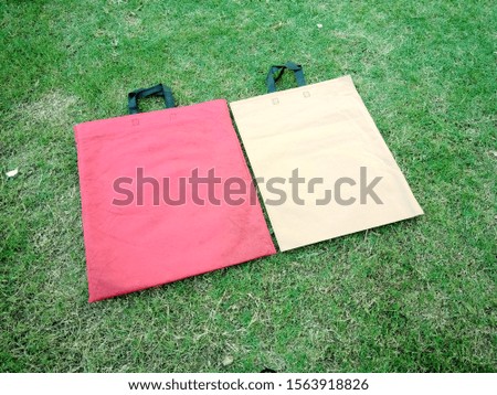 2 Eco Friendly Bags, Non Woven Bags, 2 Color Bags on green Background