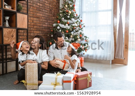 family with son and daughter enjoy playing during christmas day at home