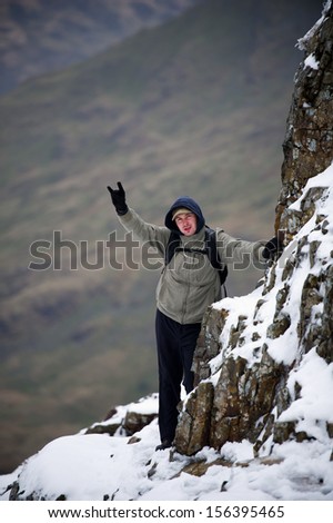 Man hiking in Snowdonia at winter, Crib Goch Mountain. Snowdonia National Park, North Wales, England, United Kingdom, Great Britain, UK, Eng, GB, Europe.