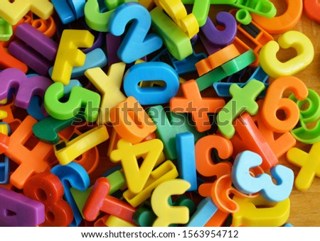 Closeup of very colorful and bright numers and letters on a pile