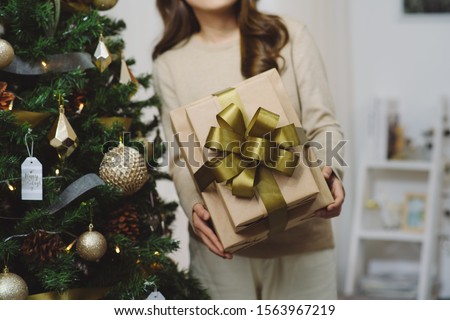 Asian woman with X-Mas gifts at home. Holidays New Year and Christmas.