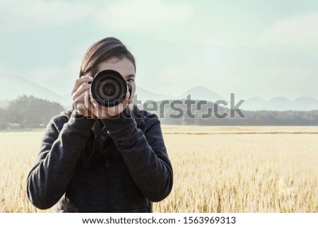 Traveler young taking photograph with rice fields background.