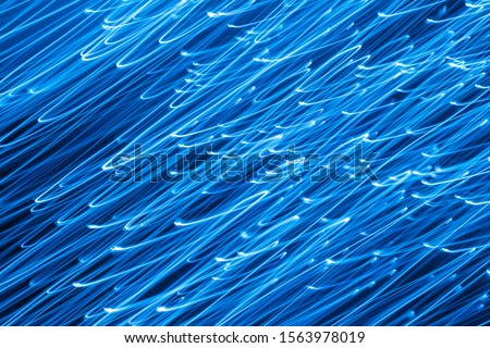 Futuristic blurred lights holiday monochrome background in classic blue. Horizontal, soft focus