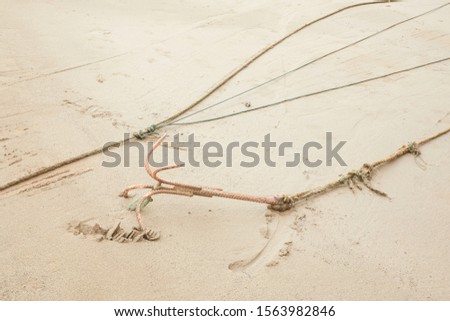 An anchor on the beach with soft sand Royalty-Free Stock Photo #1563982846