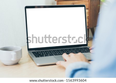 mockup image blank screen computer with white background for advertising text,hand man using laptop contact business search information on desk in office.marketing and creative work design