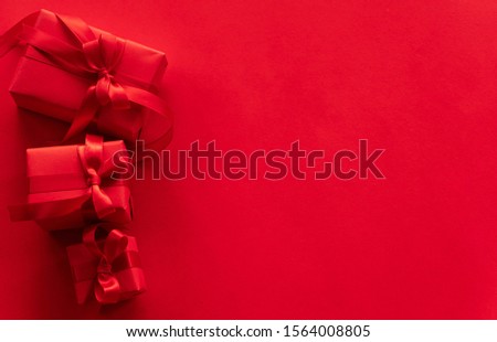 Christmas and New Year concept. Top view. Red gift box on red background with space for your text.