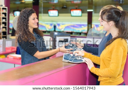 women getting their bowling shoes