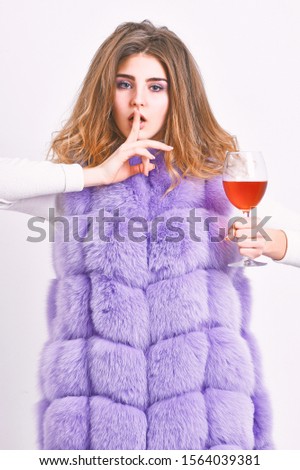 Woman enjoy wine. Hedonism concept. Lady curly hairstyle likes expensive luxury wine. Reasons drink red wine in wintertime. Girl fashion makeup wear fur coat hold wine glass. Alcohol and cold weather.