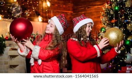 Best holiday. Elf children. Xmas children. Christmas time. Elf children. Little girl sisters in red hats. Christmas elf. Happy new year. Children like elf character. Santa claus little girls sisters.