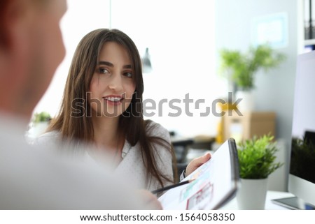 Portrait of smiling designer showing house scheme. Wonderful businesswoman telling about opportunities. Business and art design concept. Blurred background